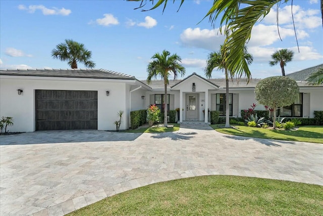 view of front of property featuring a garage and a front yard