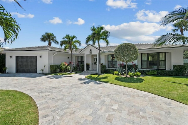 view of front of home featuring a garage and a front lawn