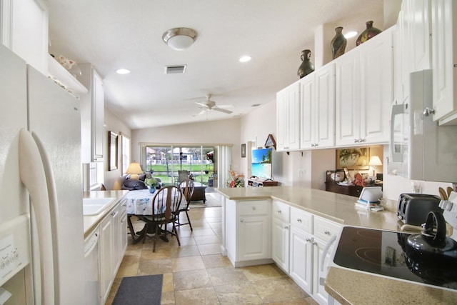 kitchen featuring light countertops, visible vents, white cabinetry, white appliances, and a peninsula