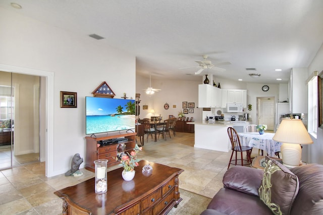 living room with ceiling fan, plenty of natural light, visible vents, and baseboards