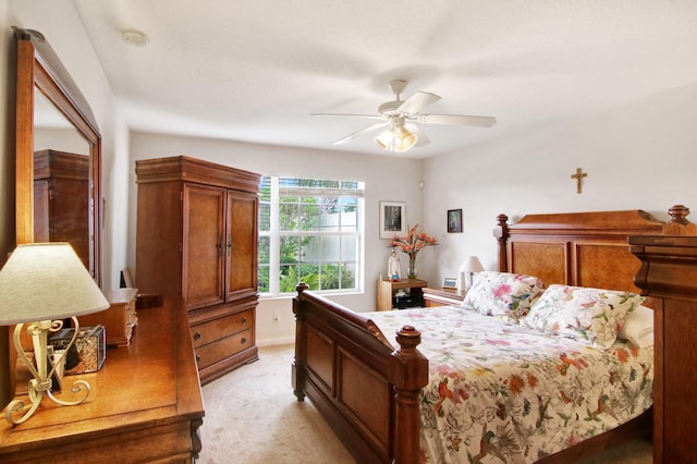 bedroom with ceiling fan and light colored carpet