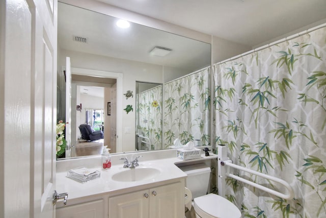 full bathroom featuring visible vents, vanity, and toilet