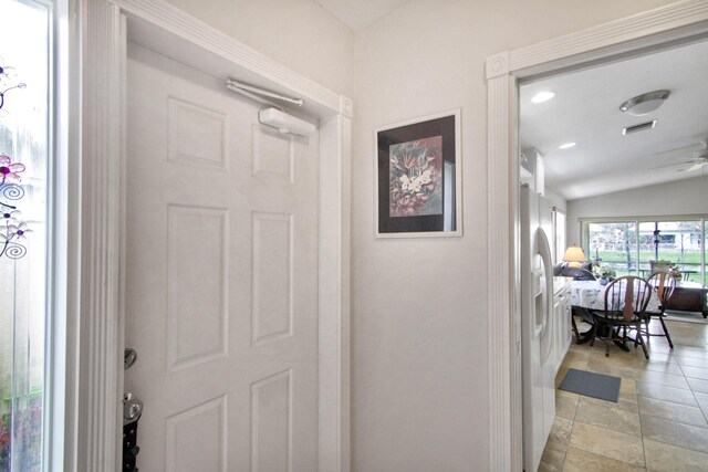 hall with lofted ceiling, visible vents, and recessed lighting