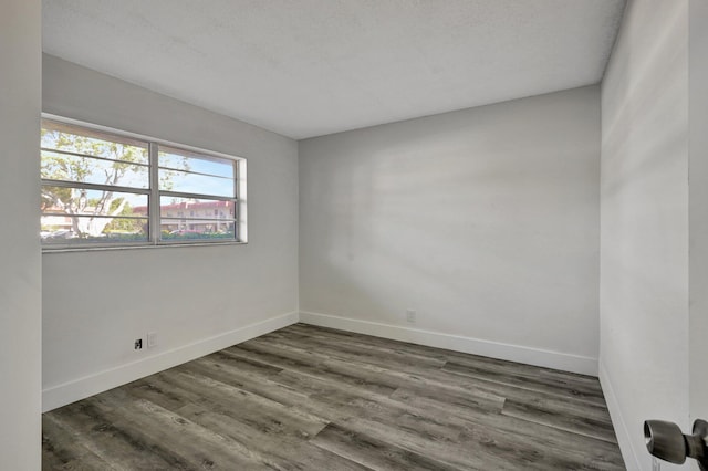 spare room with dark hardwood / wood-style floors