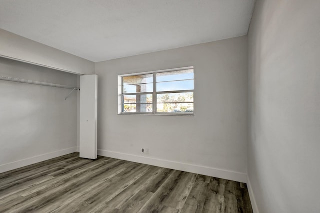 unfurnished bedroom featuring hardwood / wood-style flooring and a closet