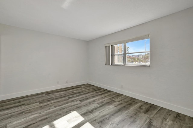 spare room featuring wood-type flooring