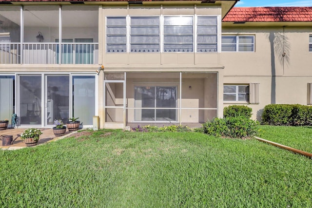 rear view of house featuring a yard