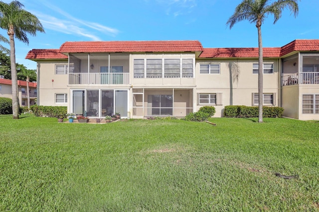 rear view of property featuring a yard