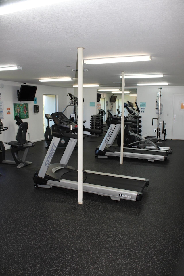 workout area featuring a textured ceiling