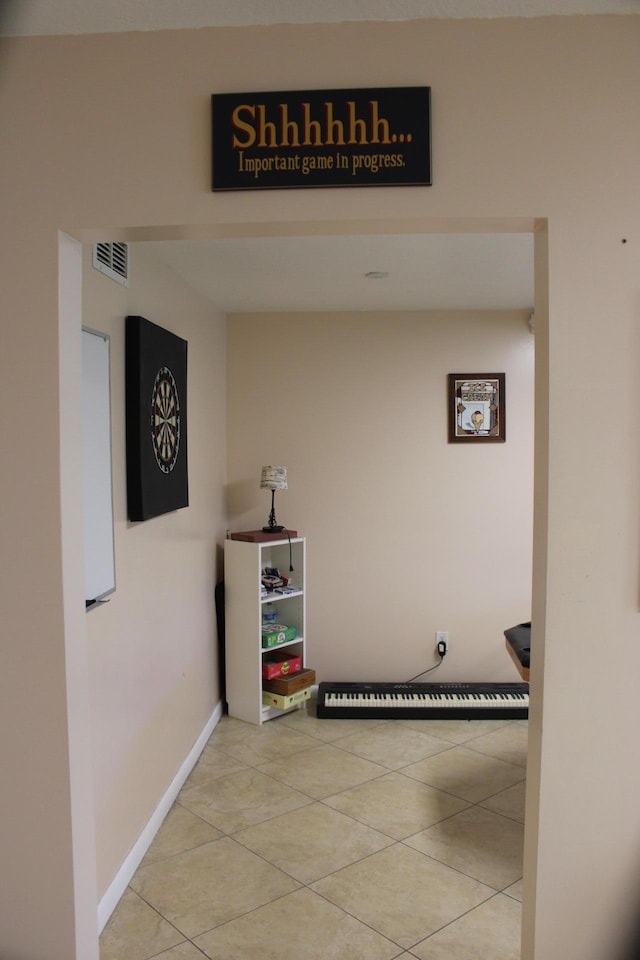 hall with light tile patterned floors