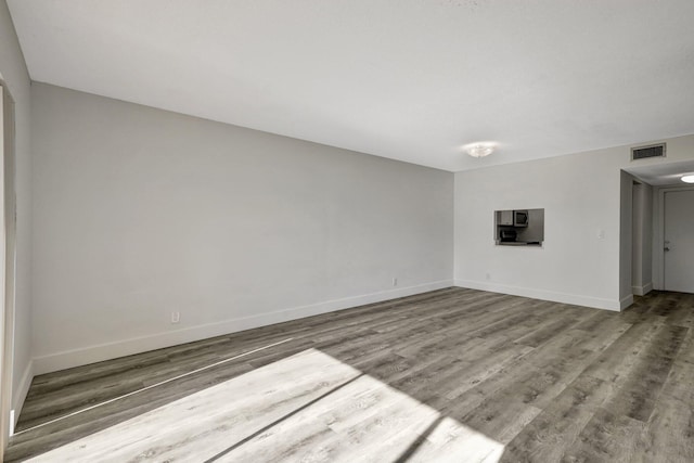 spare room with hardwood / wood-style flooring