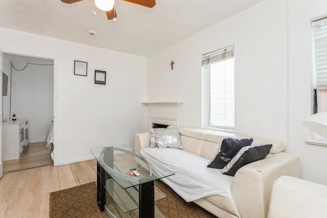 living room with hardwood / wood-style floors and ceiling fan