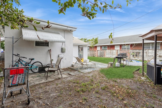 rear view of property with central AC unit