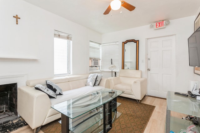 living room with cooling unit, ceiling fan, and wood-type flooring