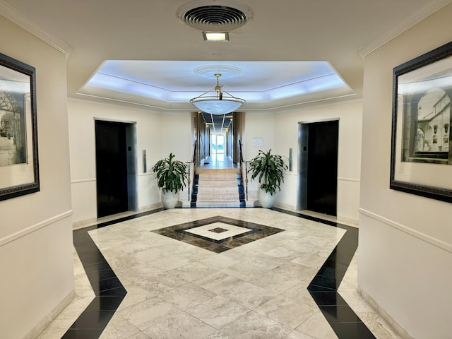 hallway featuring crown molding, a raised ceiling, and elevator