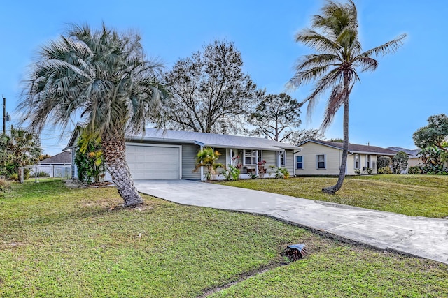 ranch-style home featuring a garage, covered porch, and a front yard