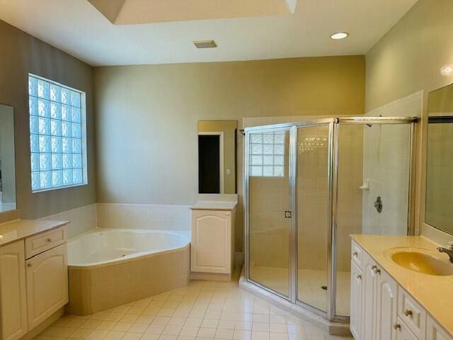 bathroom with a garden tub, tile patterned flooring, vanity, a shower stall, and recessed lighting