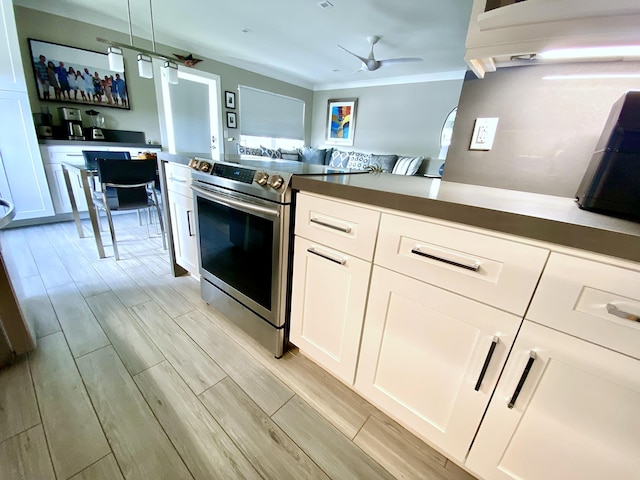 kitchen with stainless steel range with electric stovetop, white cabinetry, crown molding, and ceiling fan