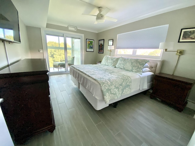 bedroom with multiple windows, ornamental molding, access to outside, and ceiling fan