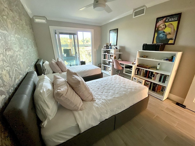 bedroom featuring ornamental molding, light hardwood / wood-style floors, and ceiling fan