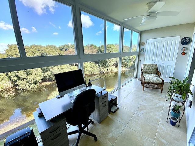 tiled office space featuring floor to ceiling windows and ceiling fan