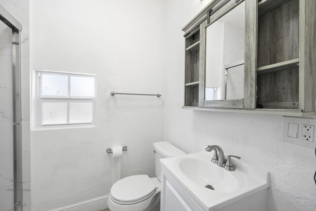 331 NW 1st Ave, Boynton Beach, FL 33435 - bathroom featuring walk in shower, vanity, and toilet
