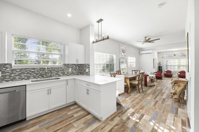 331 NW 1st Ave, Boynton Beach, FL 33435 - kitchen with white cabinetry, sink, kitchen peninsula, and dishwasher