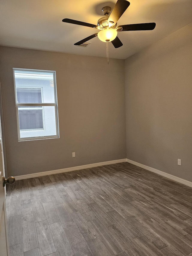 spare room with hardwood / wood-style flooring and ceiling fan