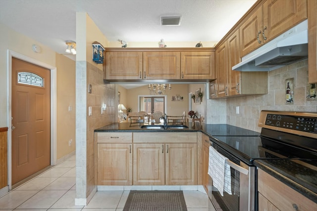 kitchen featuring sink, tasteful backsplash, light tile patterned floors, electric range, and dark stone counters