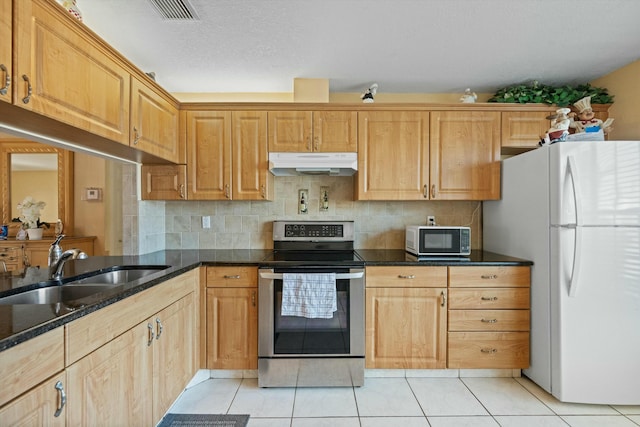 kitchen with sink, light tile patterned floors, backsplash, stainless steel electric range oven, and white fridge