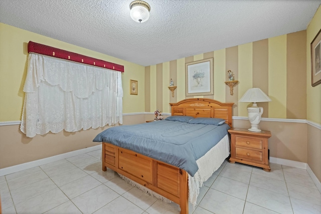 tiled bedroom featuring a textured ceiling