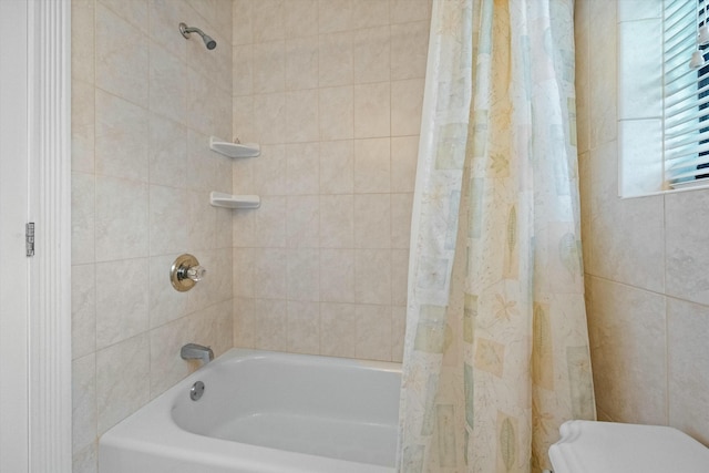 bathroom with shower / bath combo with shower curtain