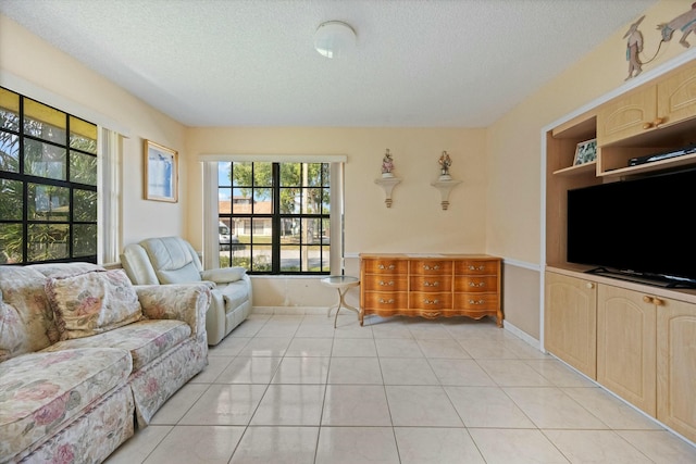 tiled living room featuring a textured ceiling