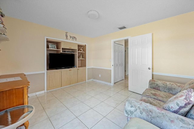 tiled living room with a textured ceiling