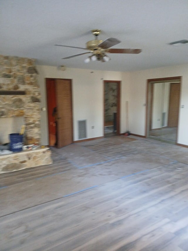 unfurnished living room featuring light hardwood / wood-style floors and ceiling fan