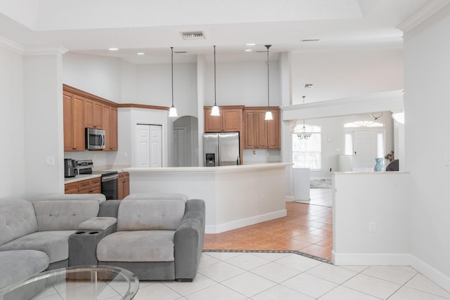 kitchen featuring stainless steel appliances, visible vents, open floor plan, light countertops, and decorative light fixtures