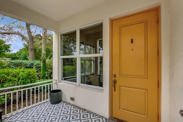 view of exterior entry featuring a balcony