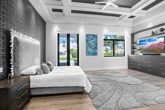 bedroom with hardwood / wood-style flooring, coffered ceiling, and access to outside