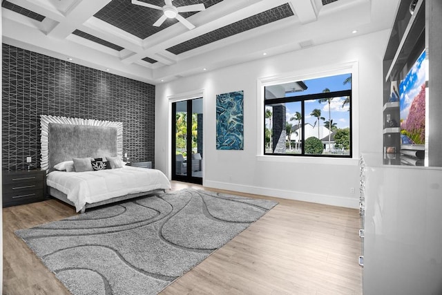 bedroom with hardwood / wood-style flooring, coffered ceiling, access to exterior, and beamed ceiling