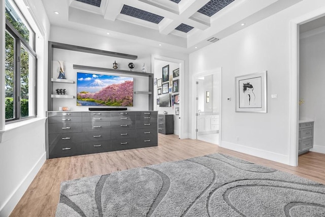 living room featuring coffered ceiling, a wealth of natural light, light hardwood / wood-style floors, and beamed ceiling