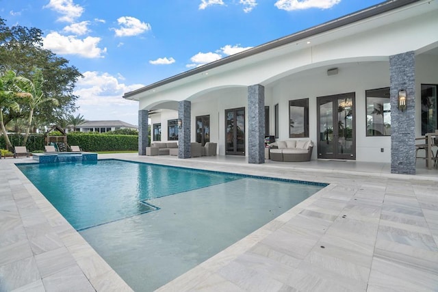 view of swimming pool featuring french doors, outdoor lounge area, and a patio