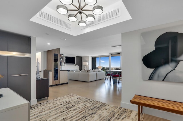 kitchen featuring light countertops, a wall of windows, modern cabinets, and an inviting chandelier