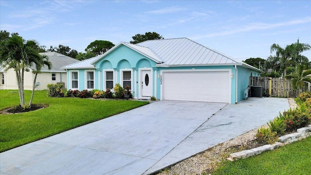 ranch-style house featuring central AC, a garage, and a front lawn