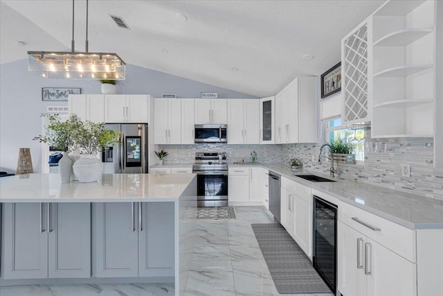 kitchen featuring a kitchen island, sink, wine cooler, white cabinets, and stainless steel appliances