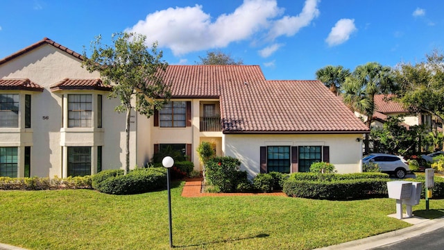 mediterranean / spanish home with a front yard