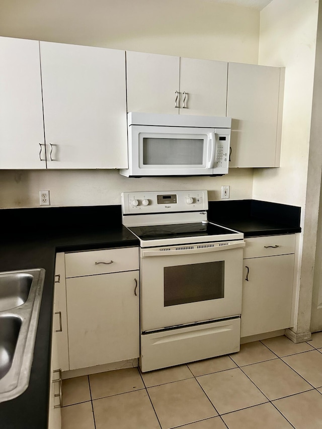 kitchen featuring sink, white cabinets, and white appliances