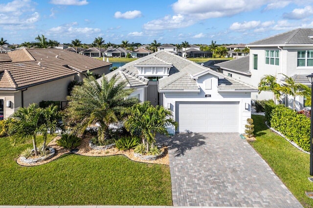 view of front of house featuring a garage and a front lawn