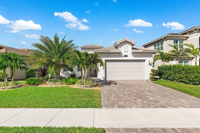 view of front of home featuring a garage and a front yard