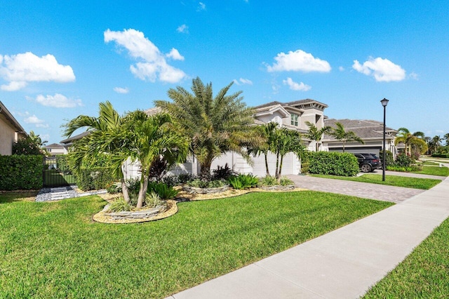 view of front of house featuring a garage and a front lawn