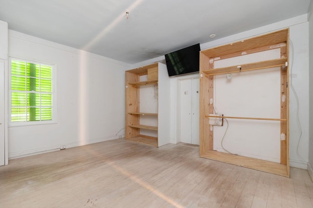 unfurnished bedroom with a closet and light wood-style flooring